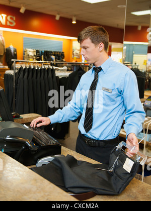 Caucasian man working in men's clothing store Stock Photo