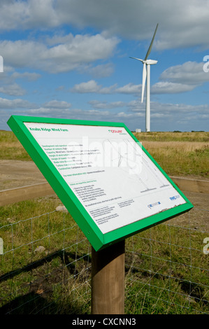 Information board by giant wind turbine towering over farmland in countryside - Knabs Ridge onshore wind farm near Harrogate, North Yorkshire, England Stock Photo