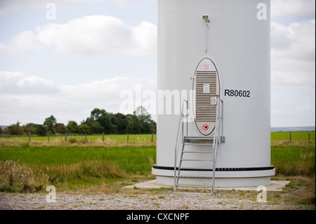 Close-up of base of giant white wind turbine tower & ventilated access door - Knabs Ridge onshore wind farm near Harrogate, North Yorkshire, England. Stock Photo