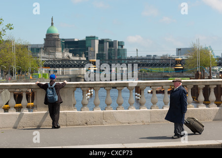 View from O'Connell bridge over river Liffey to Custom house and Financial Services Centre FSC. Dublin, Ireland. Stock Photo