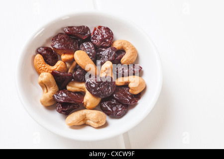 Very small meal or snack of dried cherries and cashew nuts. Stock Photo