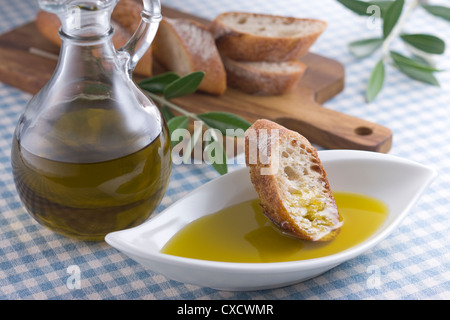 Dipping Bread into Olive Oil Stock Photo