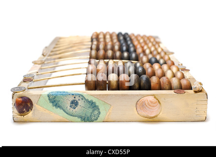 abstract composition from the old wooden abacus, coins and shells isolated on white background, selective focus Stock Photo