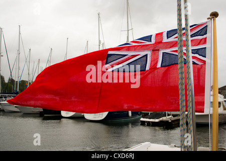 Red ensign flying on the aft of a boat in a marina, Falmouth, UK. Stock Photo