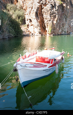 Traditionally painted wooden boat on the lake at Agios Nikolaos, Crete, Greece Stock Photo