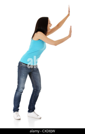 Woman pushing something imaginary isolated over a white background Stock Photo