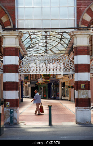 Person walking through Westbourne arcade, at Bournemouth in July Stock Photo