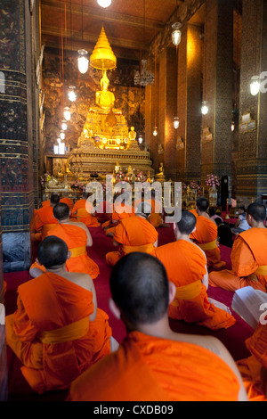 Theravada monks praying in a Buddhist temple Bangkok Thailand Stock Photo