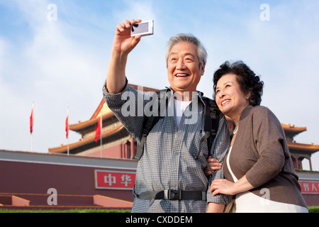 Senior couple photographing themselves at Tiananmen Square in Beijing, China Stock Photo