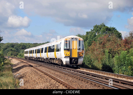 A train operated by South Eastern Trains passes through the Kent countryside heading to Ashford. Stock Photo