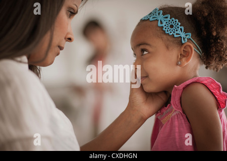 Mother comforting daughter in doctor's office Mother comforting daughter in doctor's office