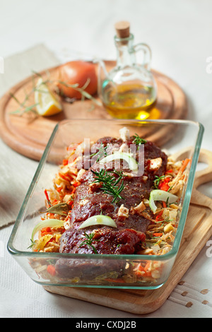 fresh raw deer meat in a glass bowl Stock Photo