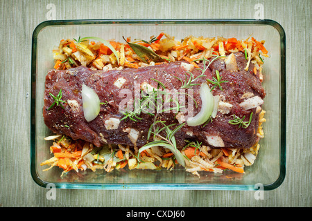 fresh raw deer meat in a glass bowl Stock Photo
