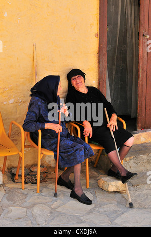 Two elderly women talking gossip Stock Photo - Alamy