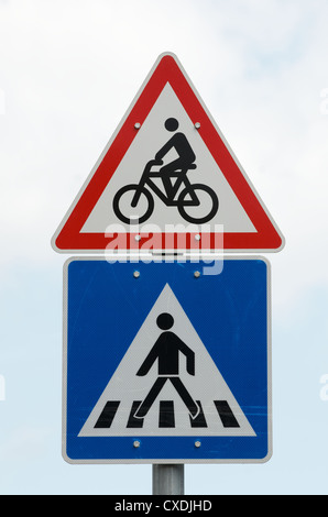 Road signs warning motorists that they are approaching a pedestrian crossing and also that cycles / bikes are crossing Stock Photo