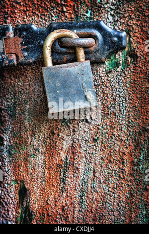 Old rusty padlock hanging on the door Stock Photo