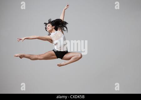 Graceful Caucasian ballet dancer in mid-air Stock Photo