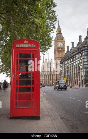 A red telephone box in London with Big Ben and a London taxi in the background Stock Photo