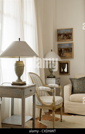 Living room chair upholstered in a pale striped linen Stock Photo