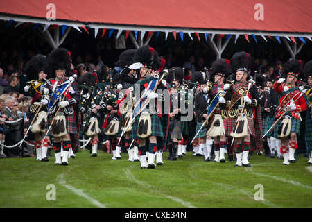 Village of Braemar, Scotland. The massed pipe bands marching at the Royal Braemar Gathering games. Stock Photo