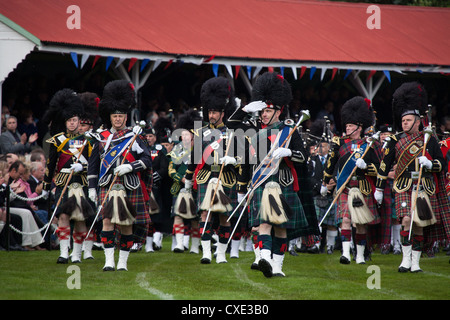 Village of Braemar, Scotland. The massed pipe bands marching at the Royal Braemar Gathering games. Stock Photo