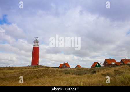 Red lighthouse and houses on island Texel, The Netherlands Stock Photo