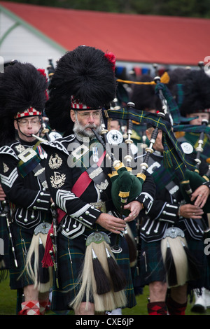 Village of Braemar, Scotland. The massed pipe bands marching at the Royal Braemar Gathering games. Stock Photo