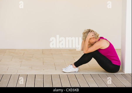 Mature woman exercising indoors Stock Photo