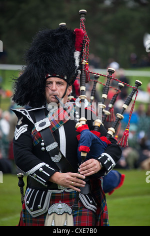 Village of Braemar, Scotland. A piper from the Blairgowrie and Rattary ...