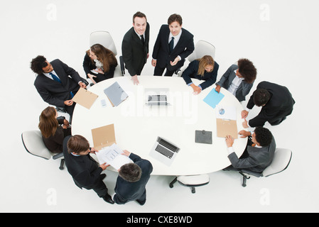 Businessman working with associates at working meeting Stock Photo