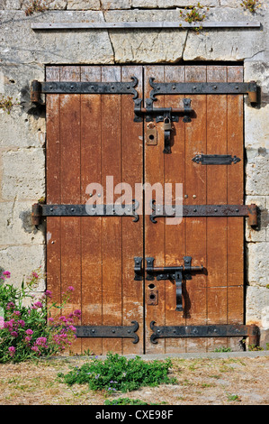 Old wooden door with heavy hinges in the citadel at Le Château-d'Oléron on the island Ile d'Oléron, Charente-Maritime, France Stock Photo
