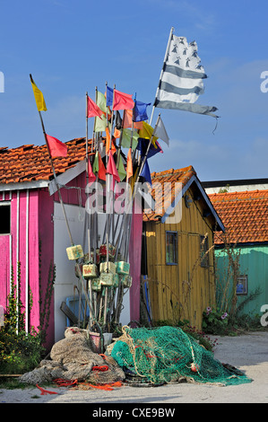 Fishing nets and markers in front of colourful cabins of oyster farmers in the port at Le Château-d'Oléron, Ile d'Oléron, France Stock Photo