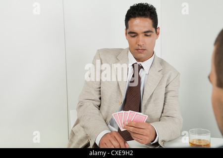 Young businessman playing cards Stock Photo