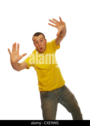 Young man dancing with hands up in the air, studio shoot on white background wearing jeans and tee shirt Stock Photo