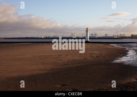 New Brighton lighthouse with Liverpool docks in background Stock Photo