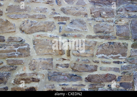 Old wall with irregular pattern of stone - background. Stock Photo