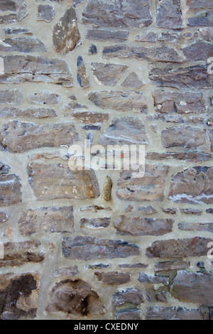 Old wall with irregular pattern of stone - background. Stock Photo