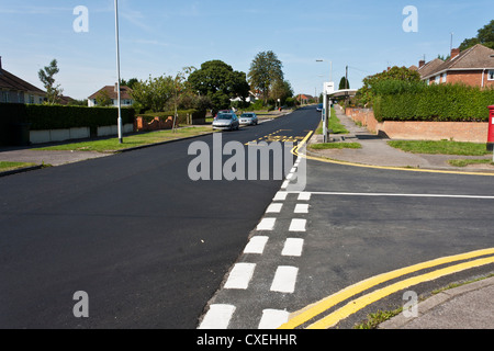Newly painted lines on a freshly tarmacked road. Stock Photo