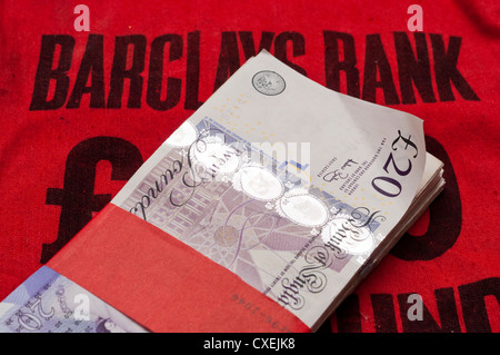 Cash on a Barclays Bank Money bag. Stock Photo