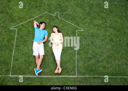 Sweet couple lying in creative house Stock Photo