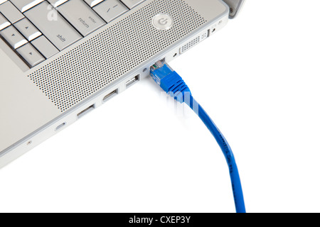 An Internet Ethernet cord  plugged into a computer on a white background Stock Photo