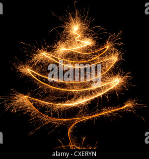 Fir tree of burning christmas sparkler on black background. Bengal fire Stock Photo