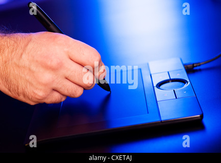 man's hand on drawing tablet Stock Photo