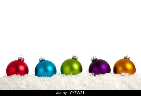Row of brightly colored Christmas ornaments on a white background with copy space Stock Photo