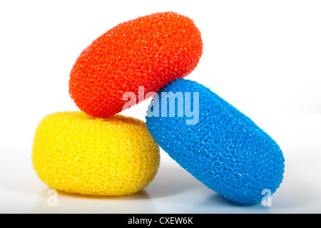 Multicolored dish scrubbers on a white background Stock Photo
