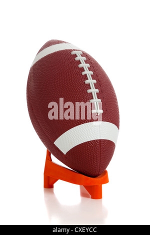 American football on kicking tee on field with goal post in background  Stock Photo - Alamy