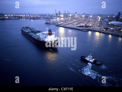 Tugboat and container ship in the port of Long Beach Stock Photo