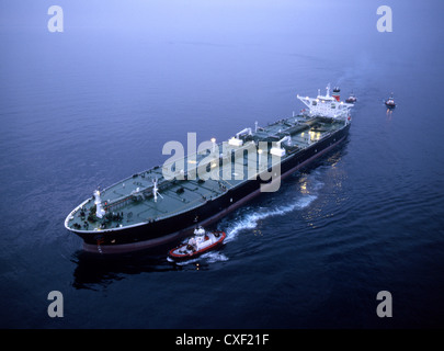 Tugboat and container ship in the port of Long Beach Stock Photo