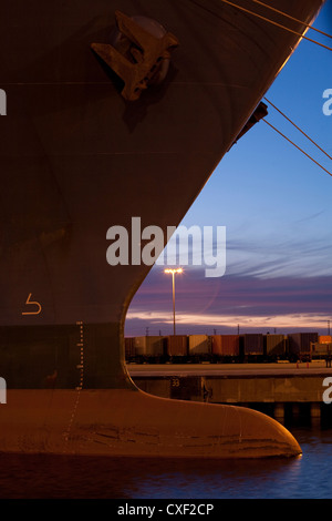 Bow of Container ship docked in harbor Stock Photo