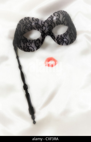 kissing lips with a venetian mask Stock Photo